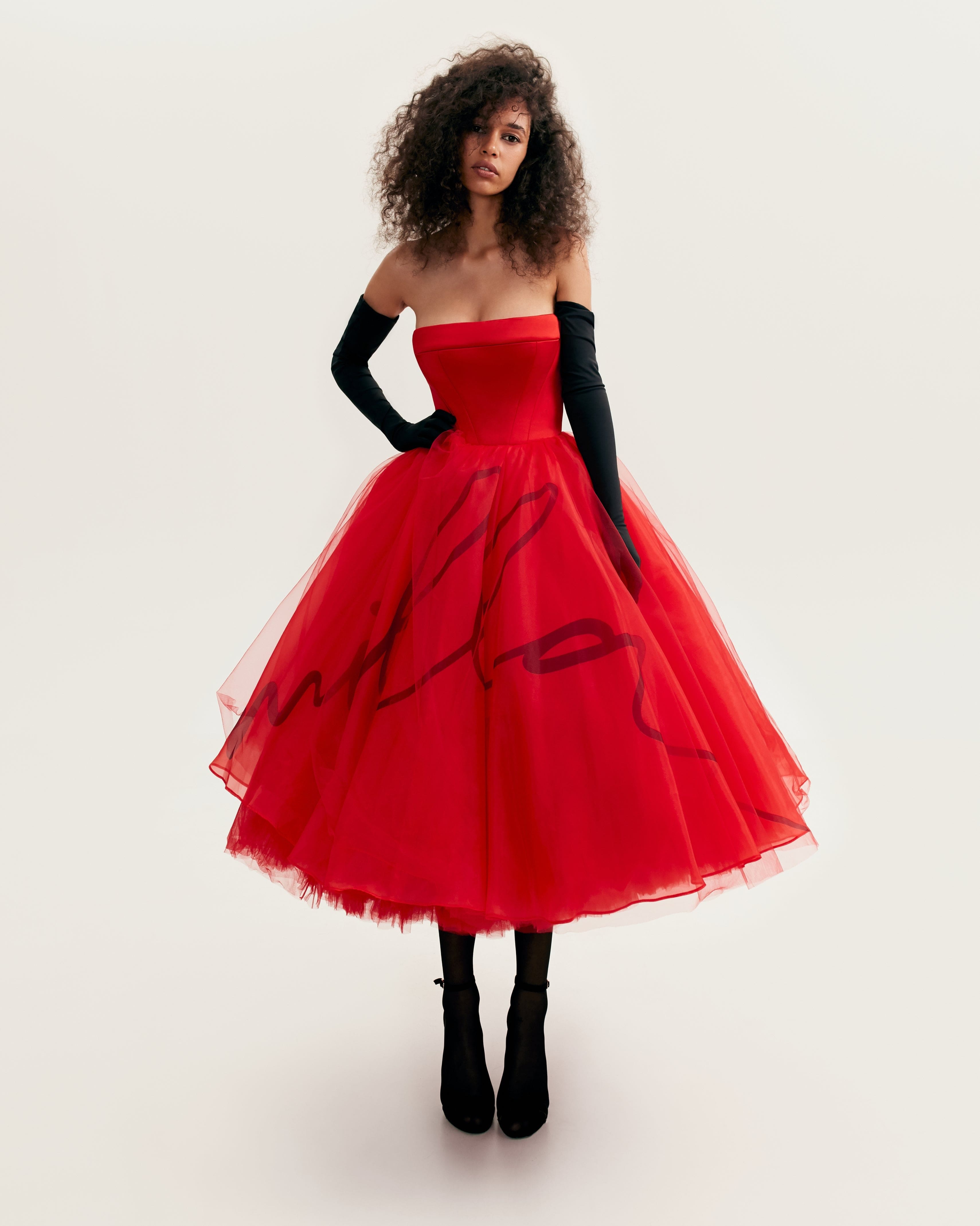 Dramatic red organza dress adorned with Milla's signature and black gloves, Xo Xo made by Milla