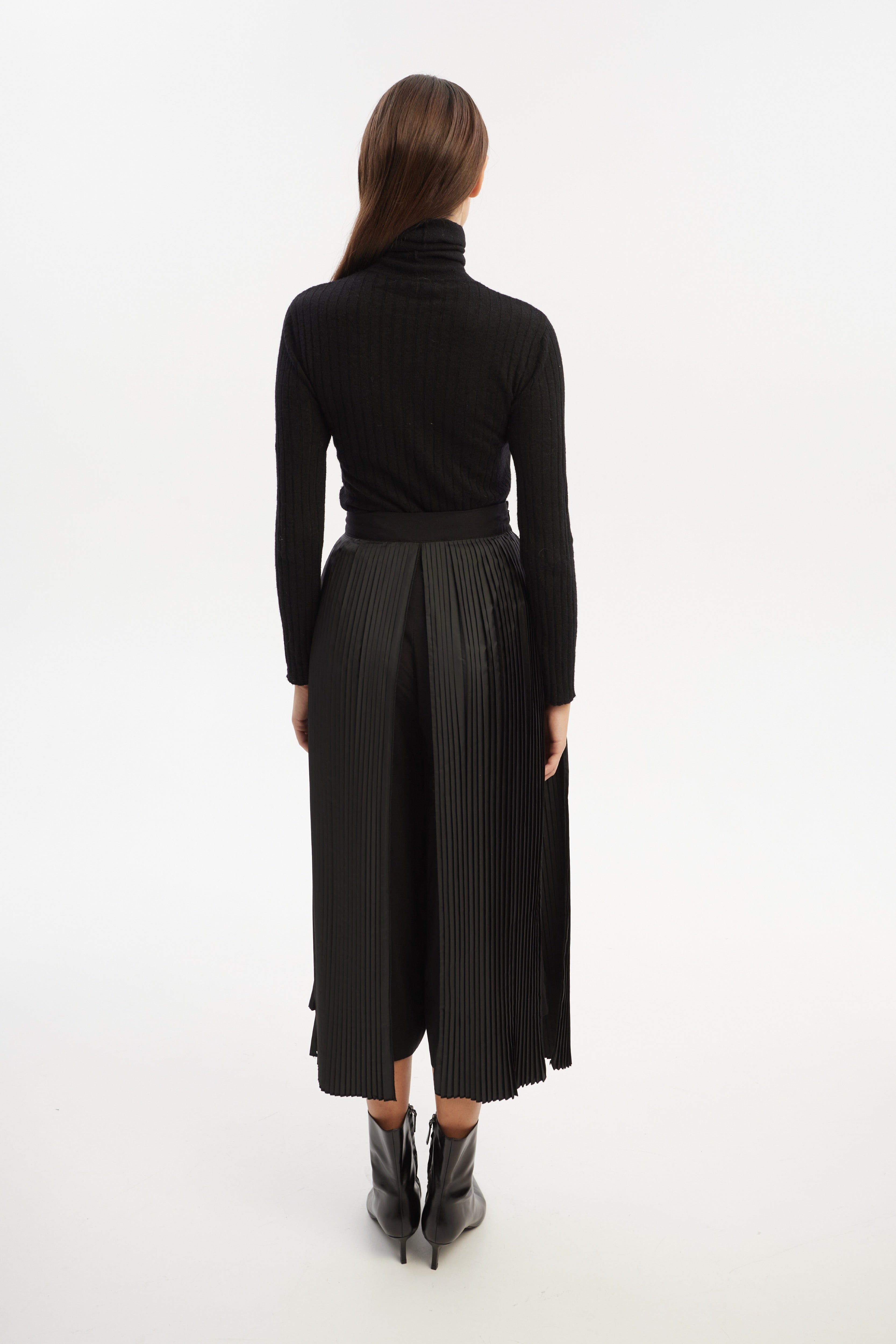 Culottes with pleated overwrap elements and detachable pockets made by Tamar Keburia