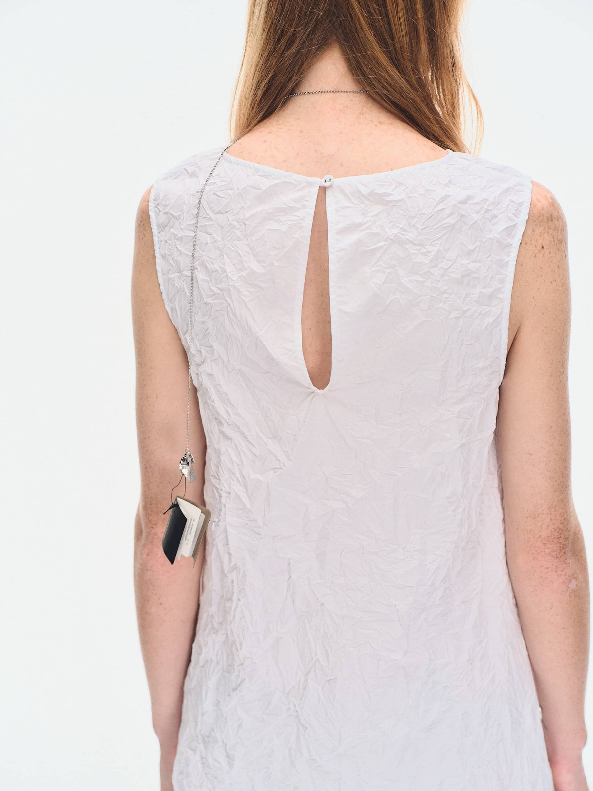 WHITE TEXTURED DRAPED MINI DRES made by YIBRI