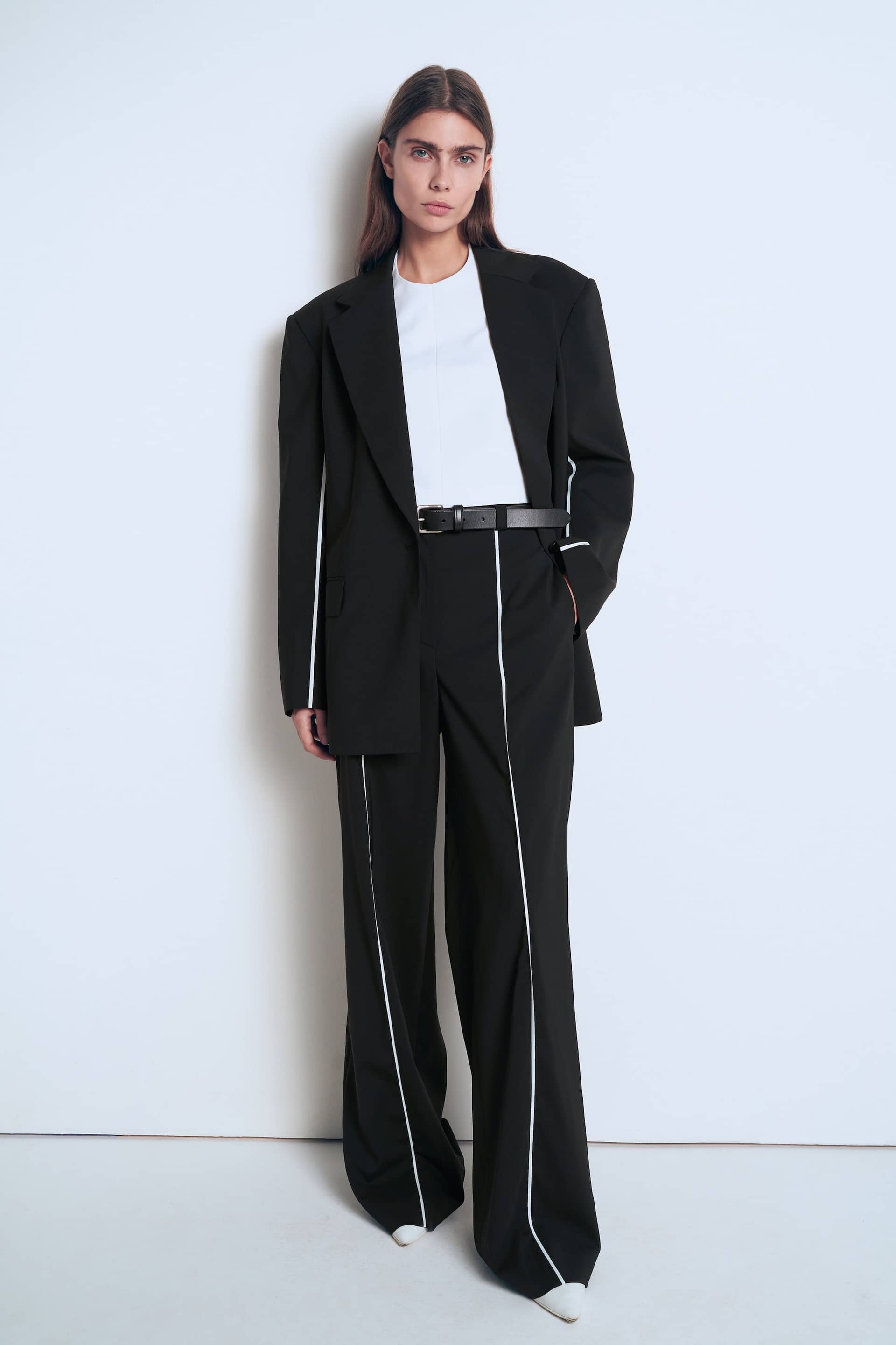 Black jacket with white piping made by A.M.G