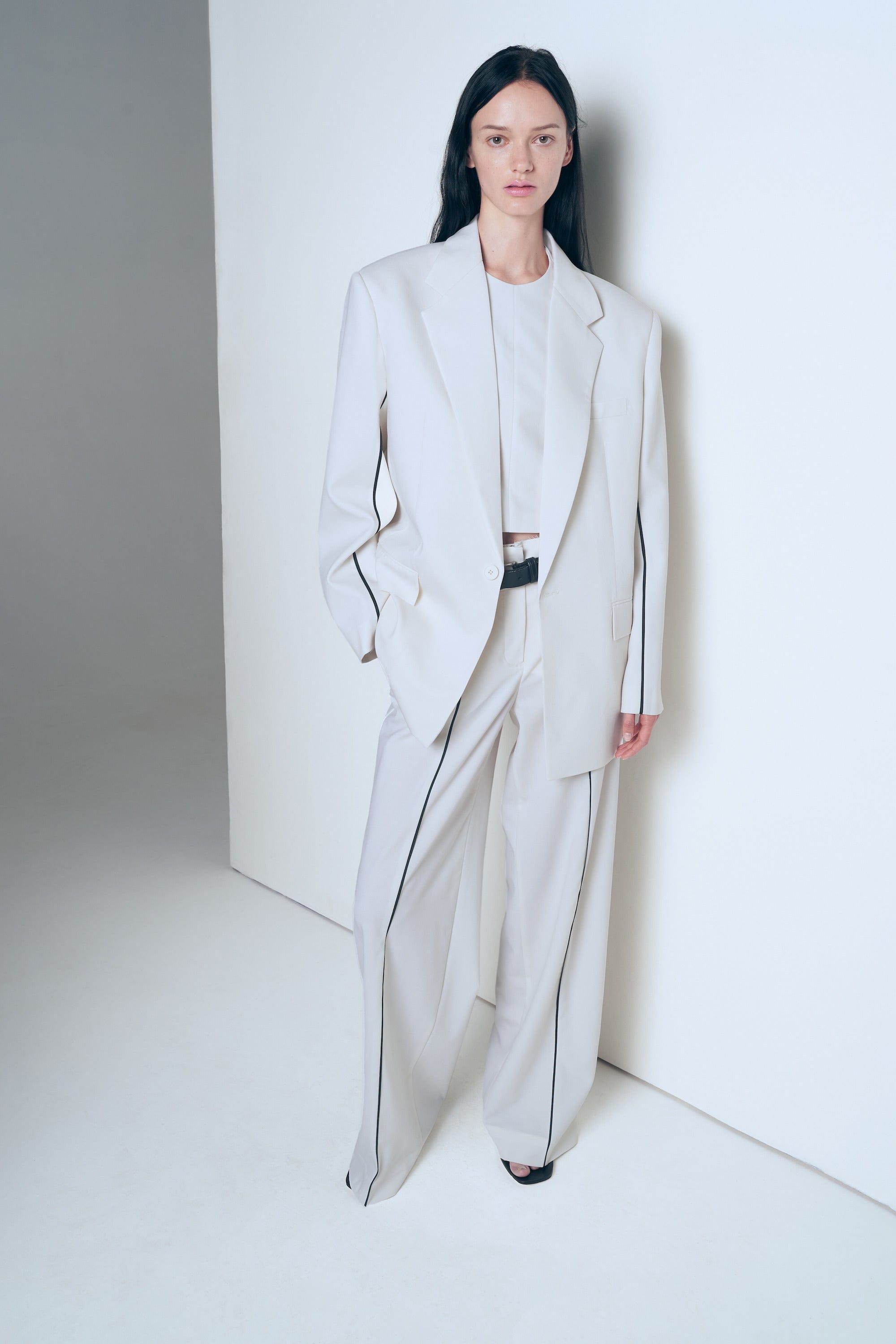 White trousers with black piping made by A.M.G